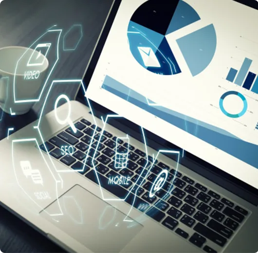 Close-up of a laptop screen displaying a circular data chart and various business analytics overlays.
