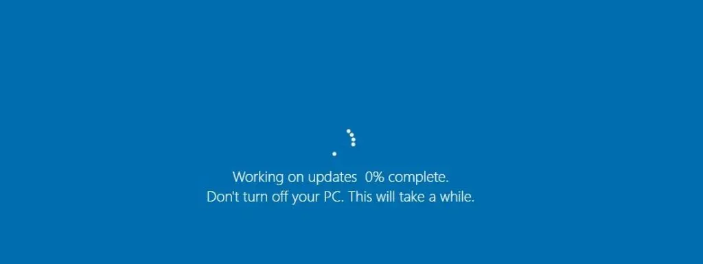 A blue Windows screen with a loading circle stating "Working on updates 0% complete. Don't turn off your PC."